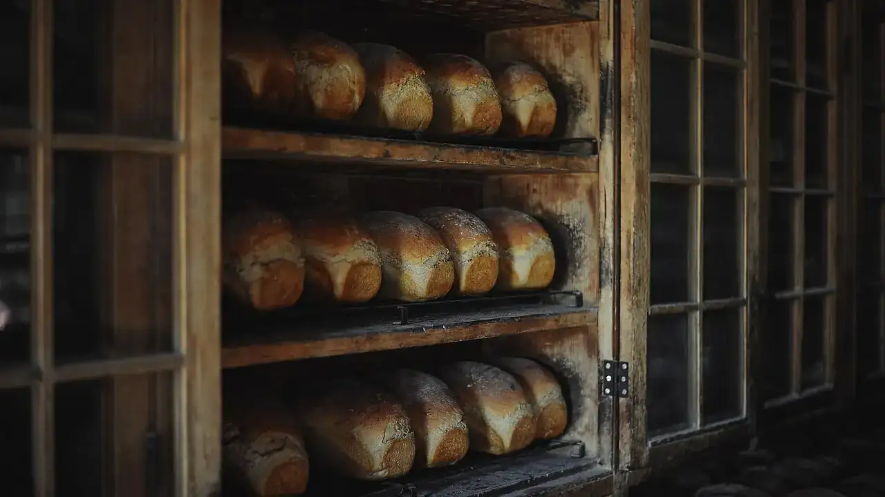Fresh loaves cooling on wooden racks